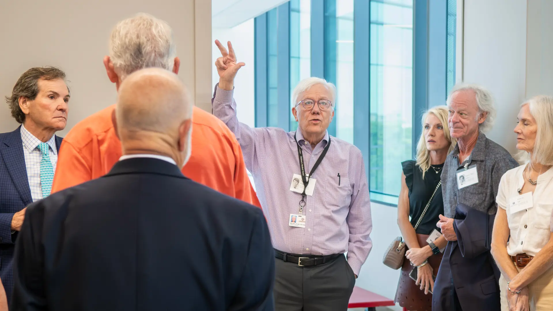 Group of men talking at a dental school class reunion.