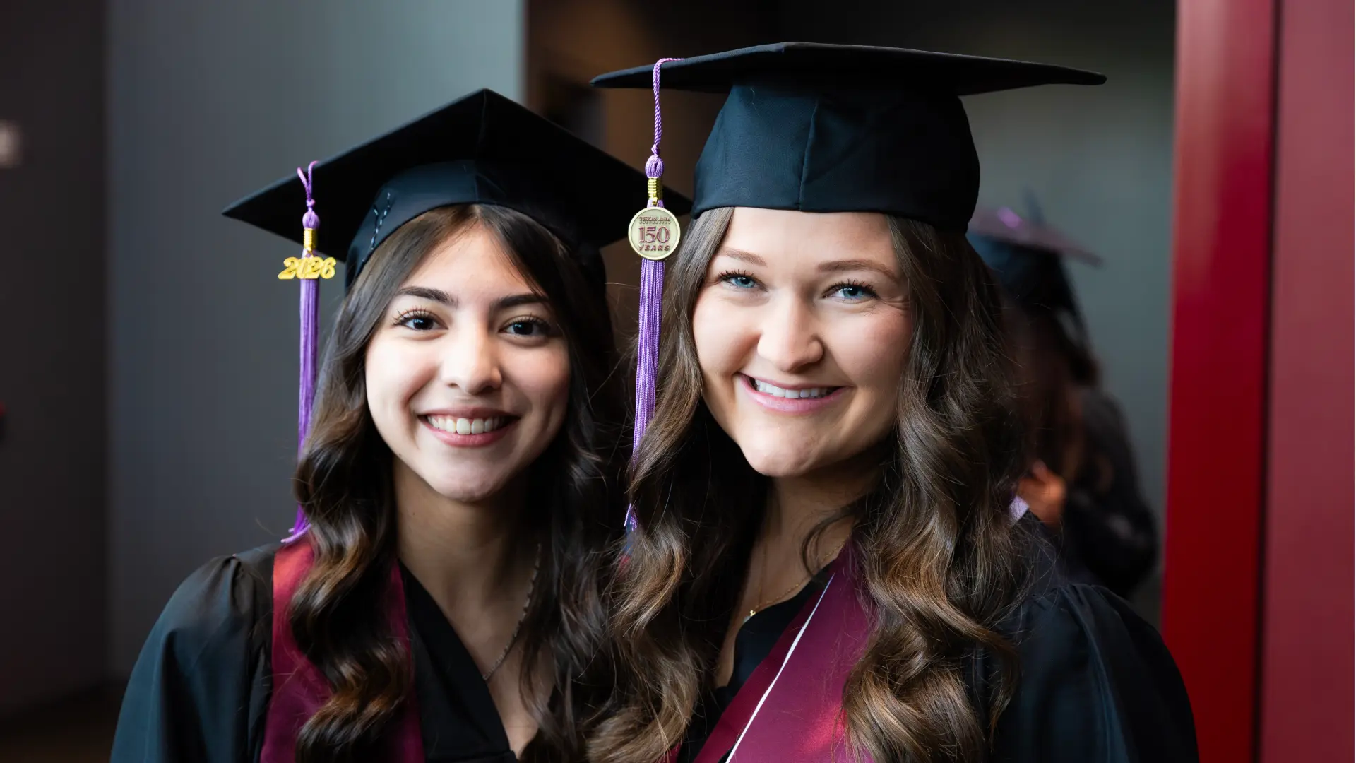 Two women dental hygiene graduates in regalia.