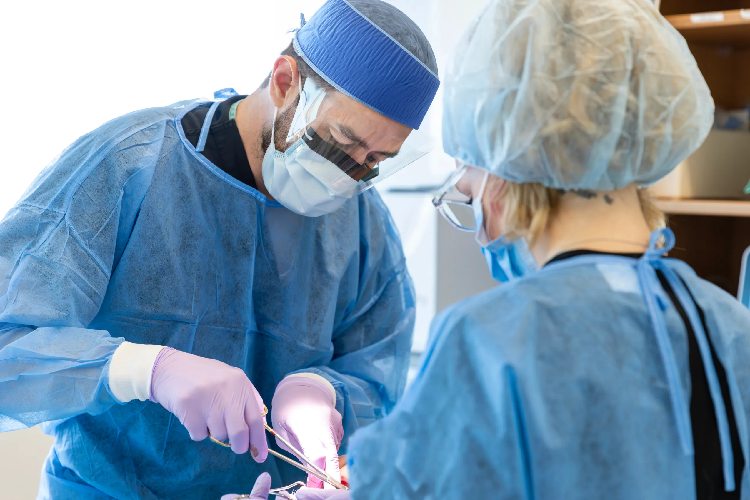 Oral surgeons in protective equipment treating a patient
