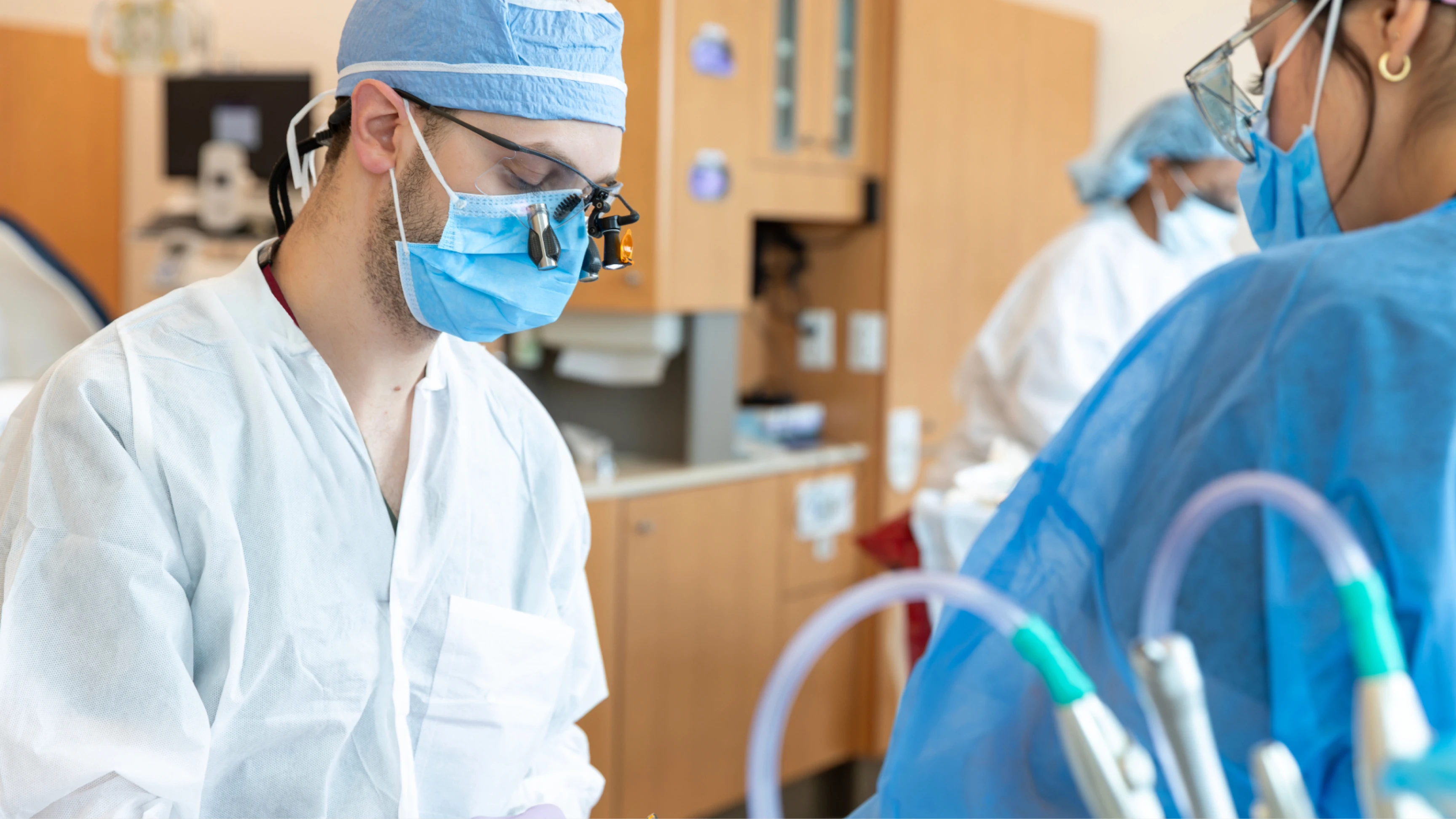 Periodontics graduate student treating a patient.